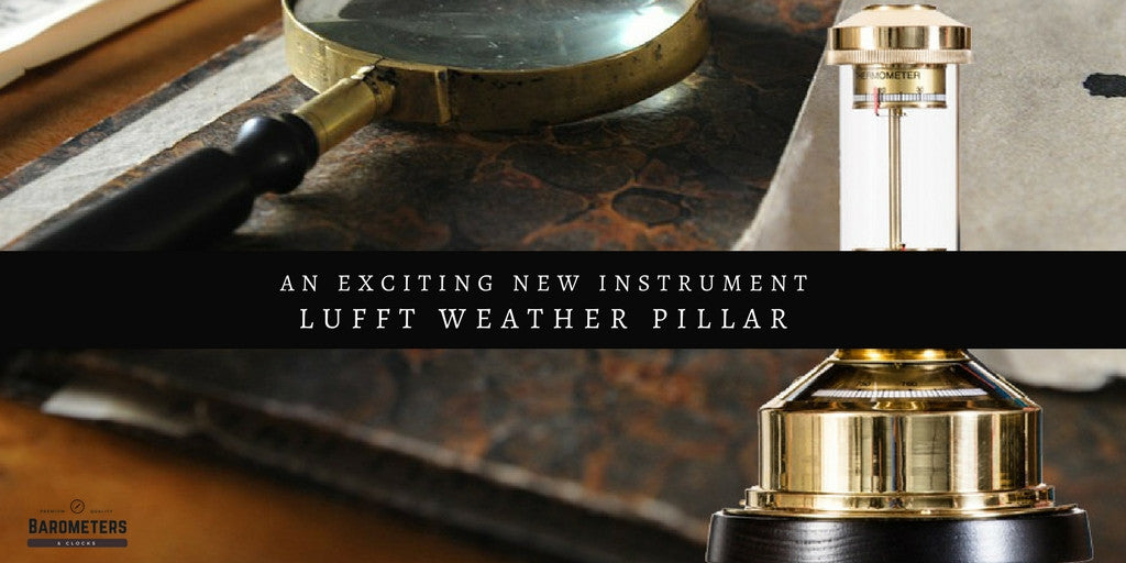 Lufft weather pillar barometer with brass base, magnifying glass, and vintage documents