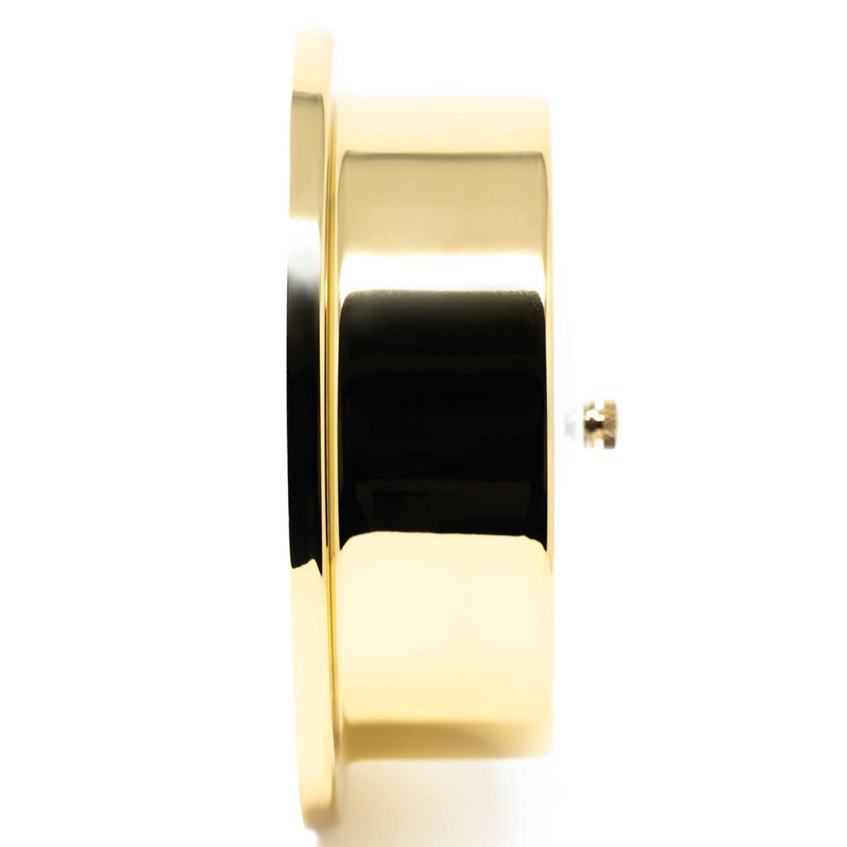 Side view of a polished brass barometer or clock case on white background