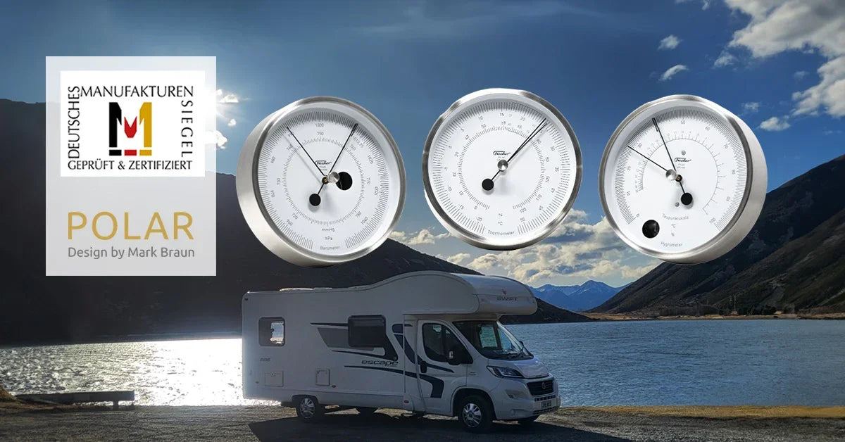 German made barometer, thermometer, and hygrometer set with white dials, displayed above a campervan by a scenic lake and mountains.