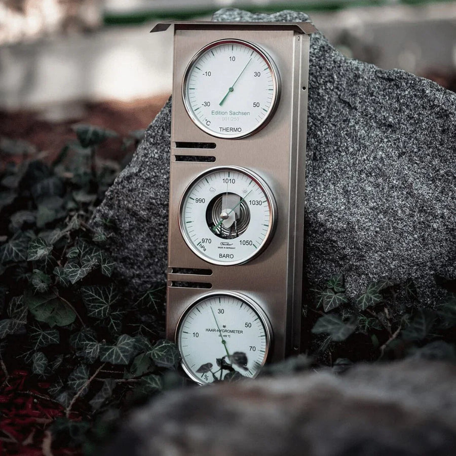 German made weather station with barometer, thermometer and hygrometer set on an outdoor rock