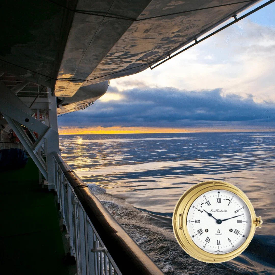 Nautical brass clock with Roman numerals overlaid on ship deck at sea during sunset