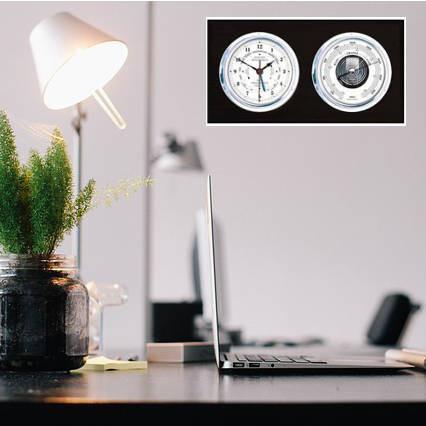 Desktop barometer and tide clock set on a modern office desk with lamp and plant