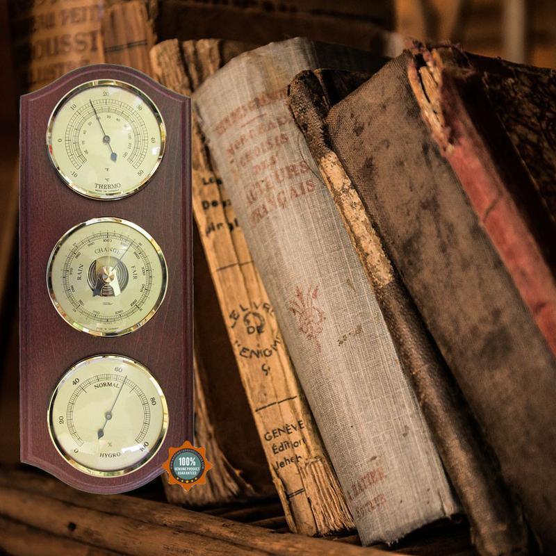 Classic wooden barometer, thermometer, and hygrometer set with antique books background