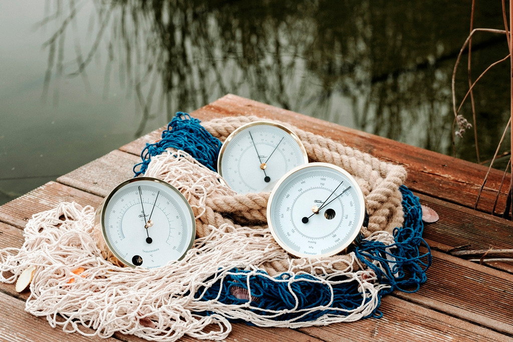 Fischer POLAR polished brass instruments resting on rope and fishing net on a timber jetty