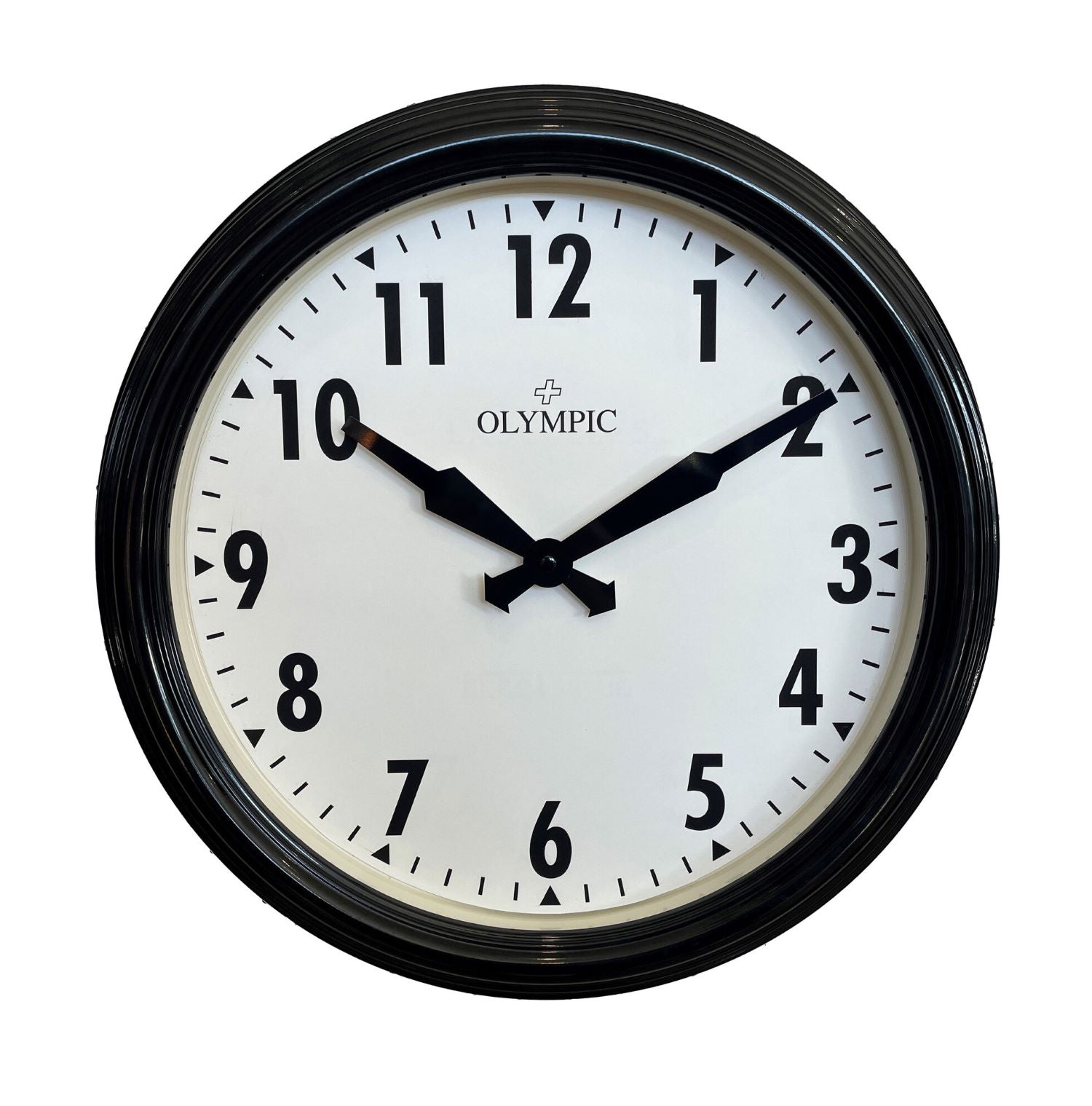 Large wall clock at a train station platform with timetable and train in background